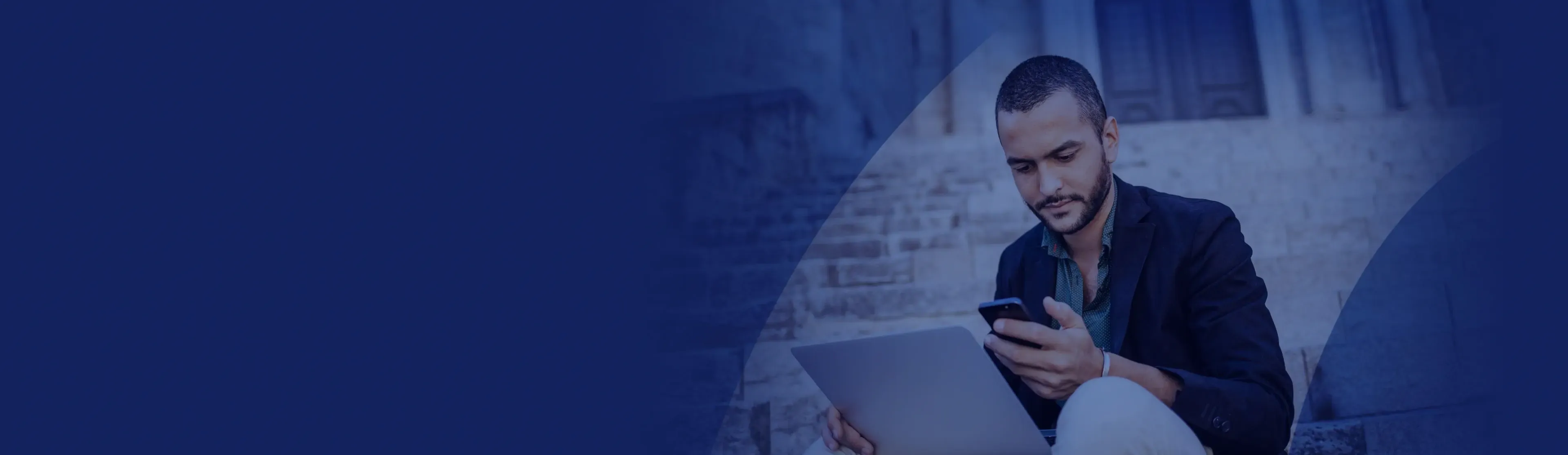 Man sitting looking at mobile phone